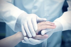 Doctor holding patient's hand